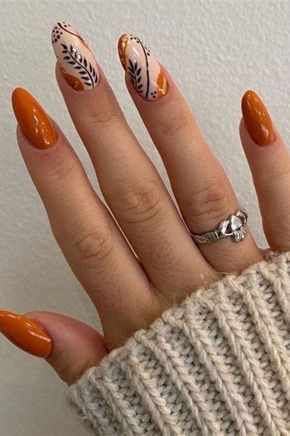 Burnt orange with leaf art almond, elegant fall nail design for women over 40