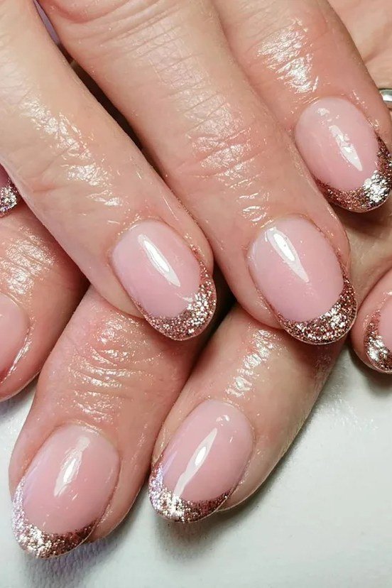 Pink nails with gold glitter french tips, best manicure idea for women over 60