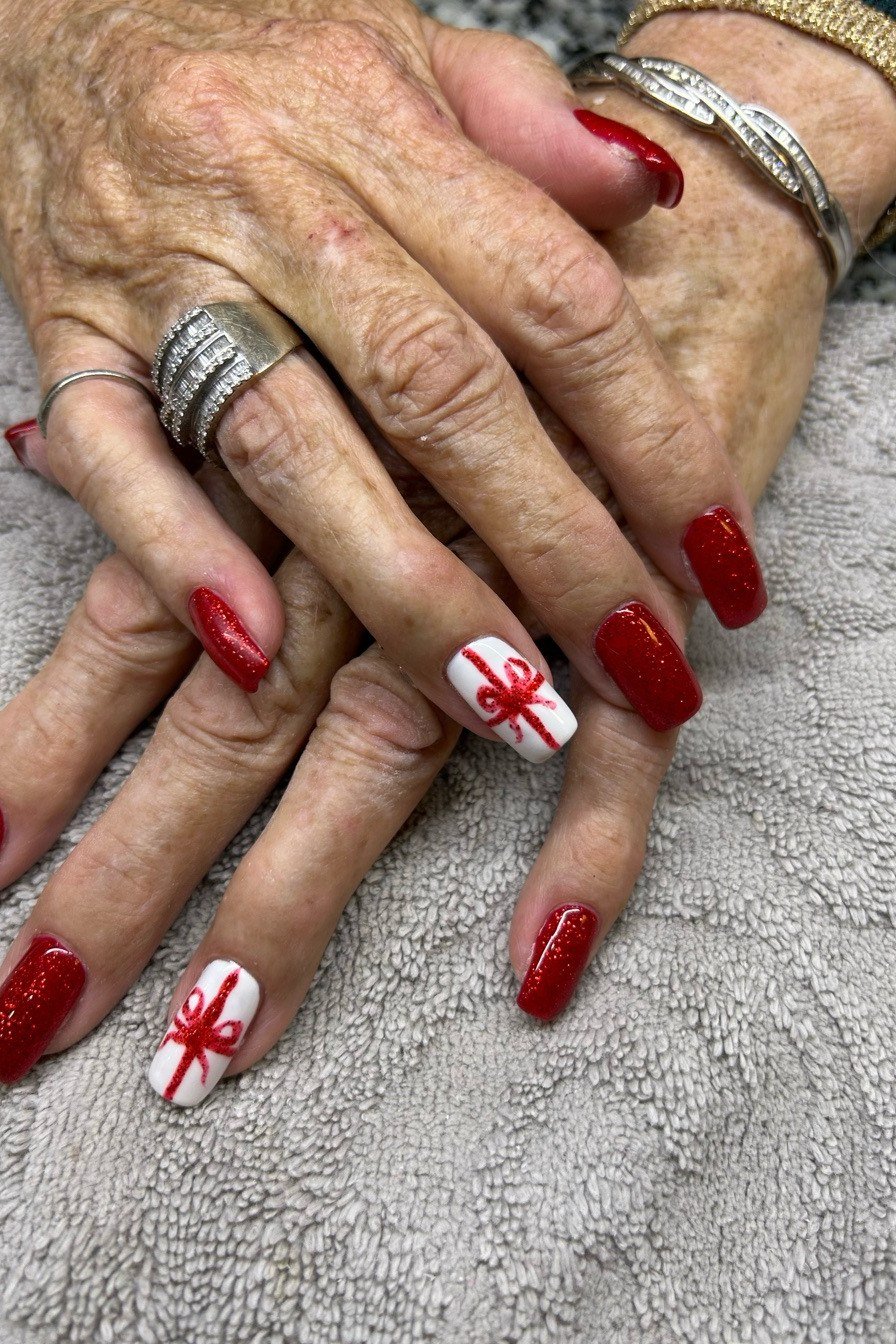 Red Snowflake Nails on Mature Hands - winter nail trend for older women over 70