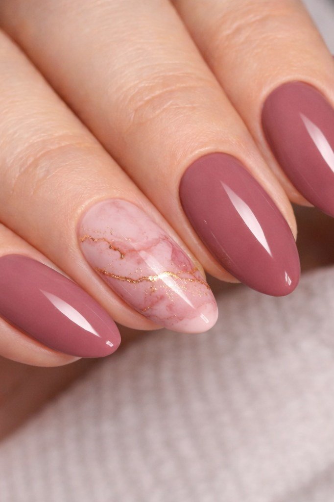 mauve almond nails with marble accent nail