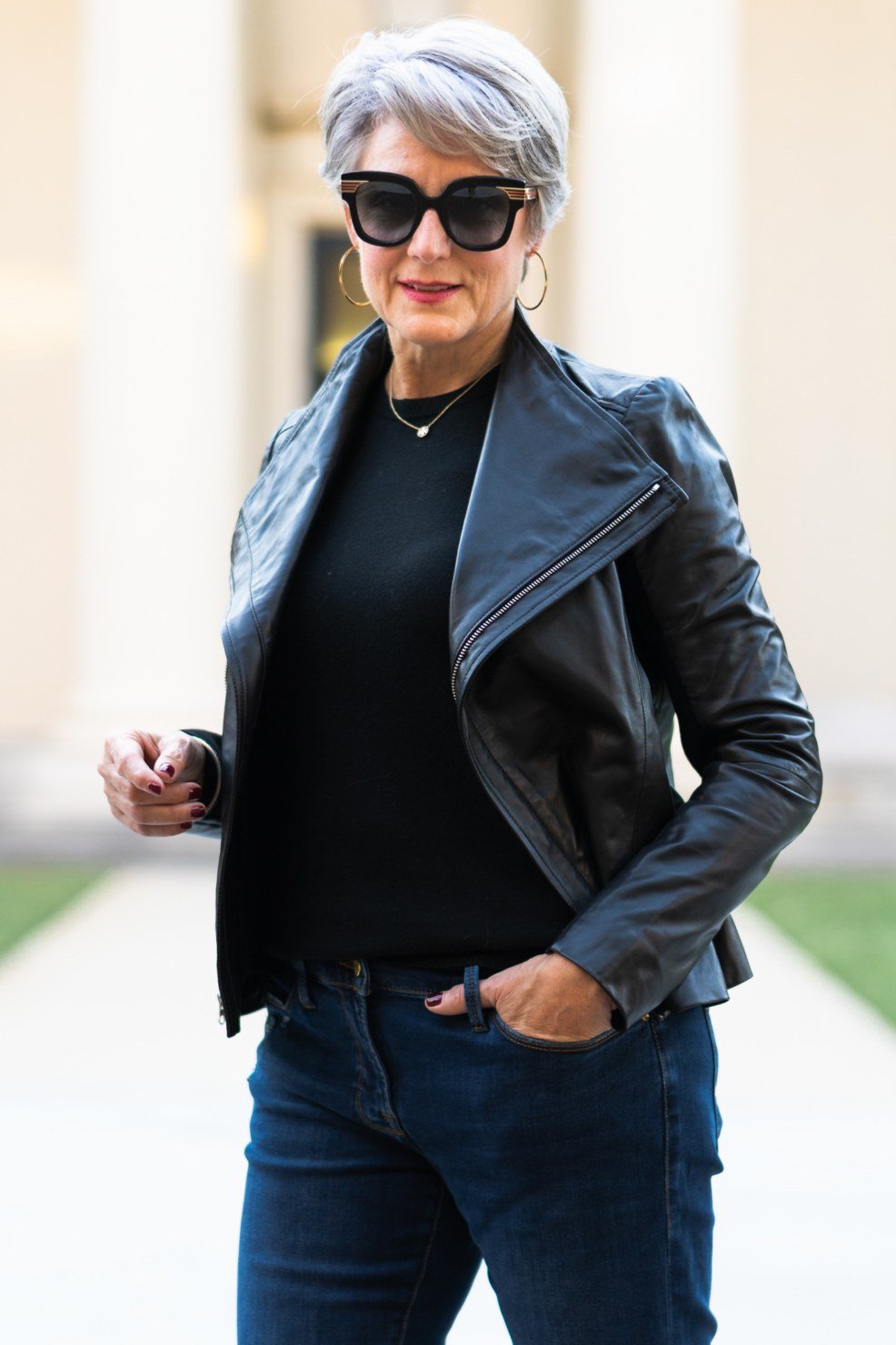 Black leather moto jacket with black top and dark jeans, fall outfit for women over 50
