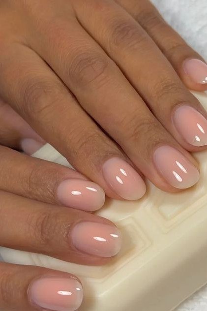 Glossy nude pink nails on soap for women over 50