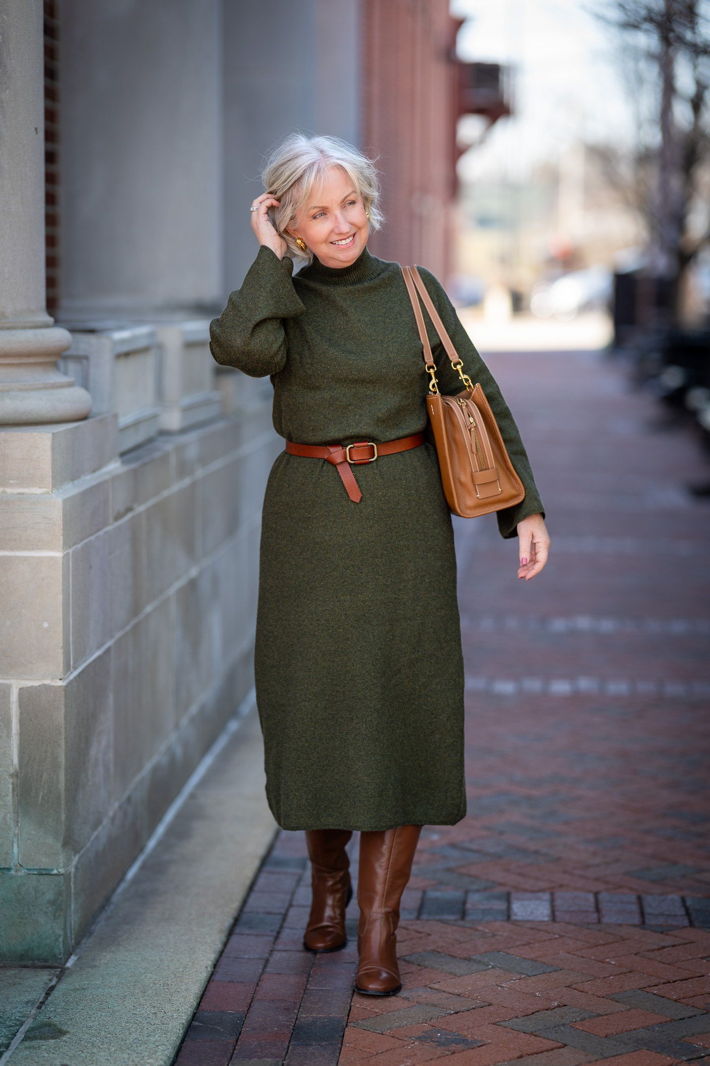 Olive-green sweater dress with tan belt and tan knee-high boots, cozy sweater outfit idea for women over 70