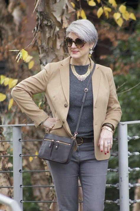 Tan blazer over grey top with grey trousers and crossbody bag, woman over 50