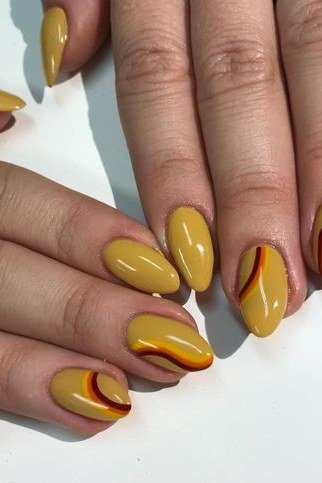 Mustard yellow with tortoiseshell french tips, almond shape, medium length, glossy, fall nail color for women over 40