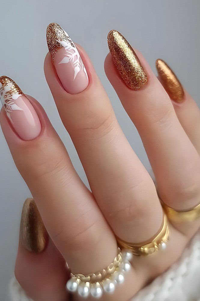 Nude with white snowflake art and gold glitter tips - Christmas nail design for older women