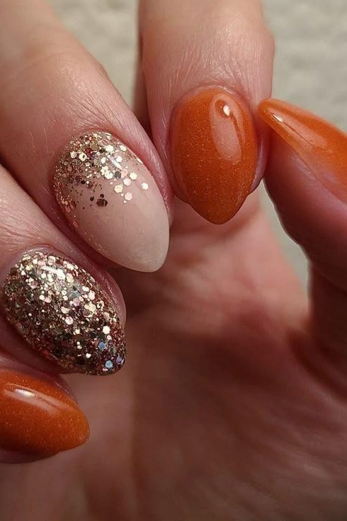 Pumpkin orange nails with gold glitter ombre, fall nail design for older women