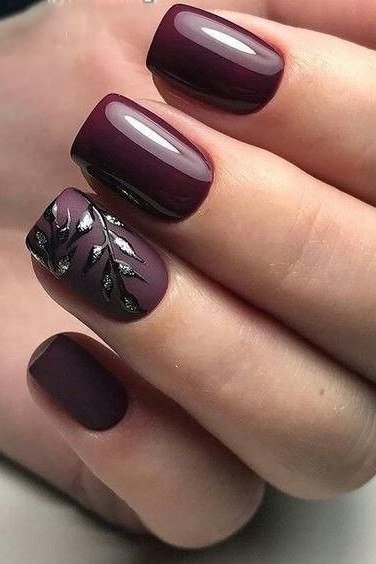 Plum gel nails with black botanical leaf art, moody modern fall manicure