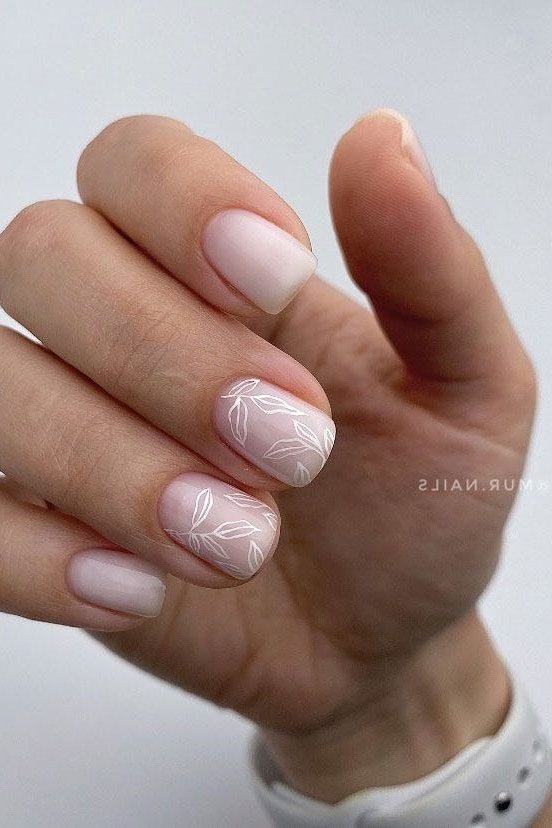 Milky Nude Almond with White Floral Accent - elegant nude nail design for women over 60