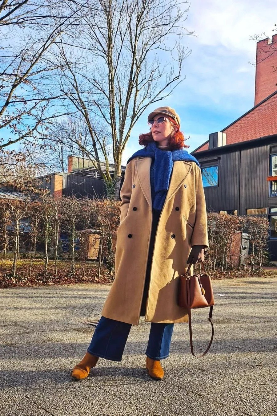 camel coat blue top blue scarf blue jeans brown boots women over 50