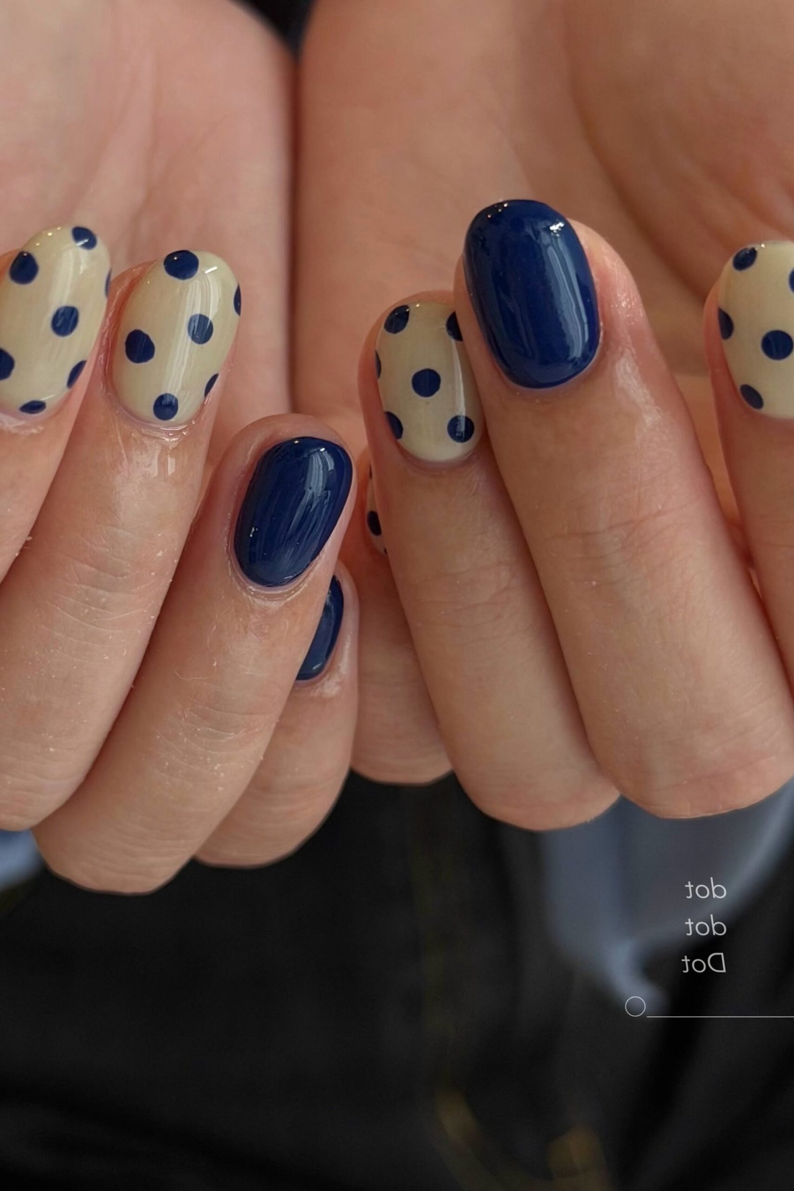 Nail art design for women over 60: navy blue nails with white polka dots