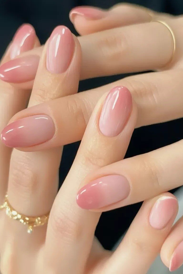 pink baby boomer fade on medium almond nails with gold rings
