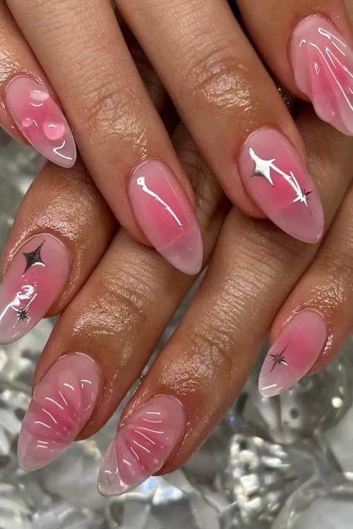 Stiletto pink jelly nails with star charms and strawberry art