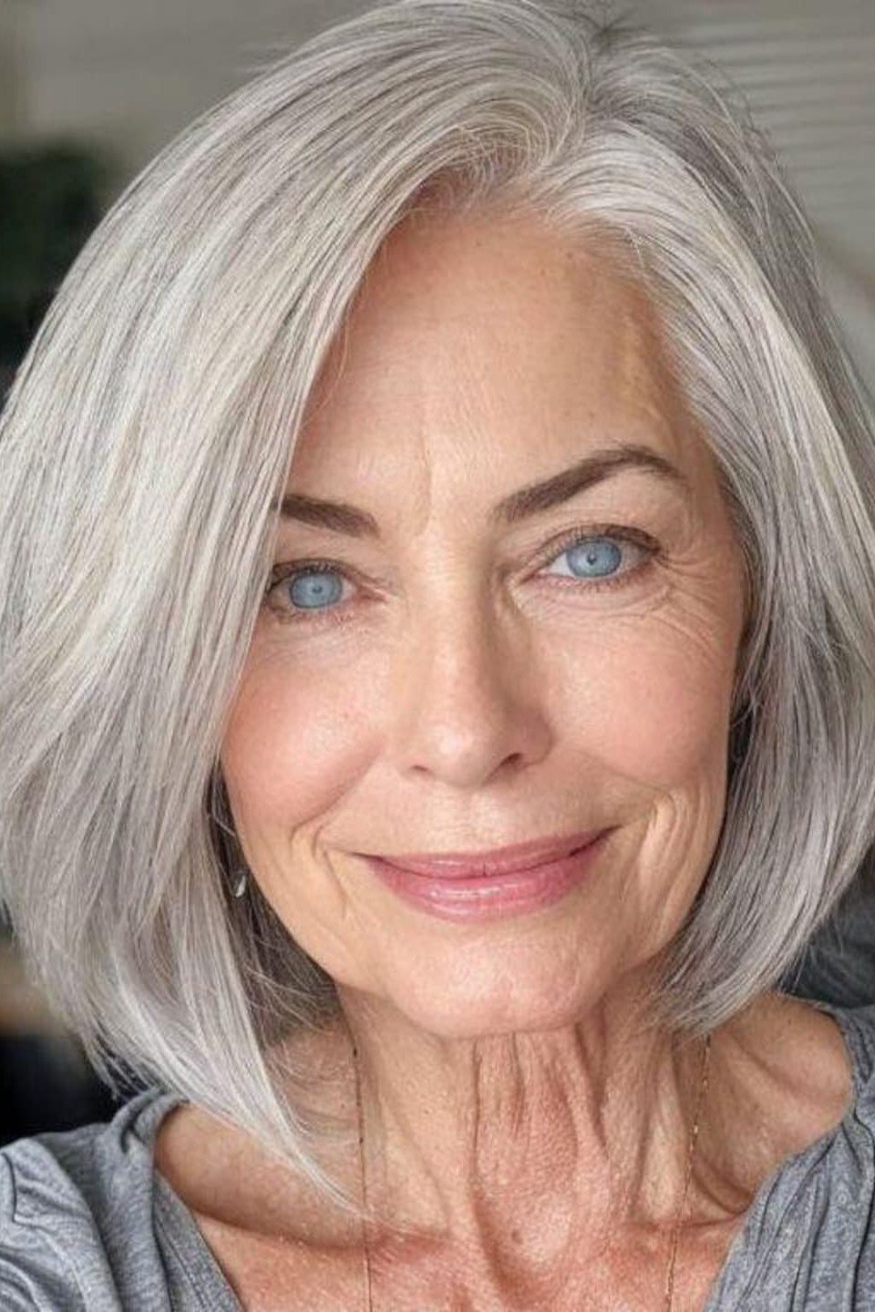 Sleek straight silver haircut on an older woman, front view, medium hairstyle for women over 60