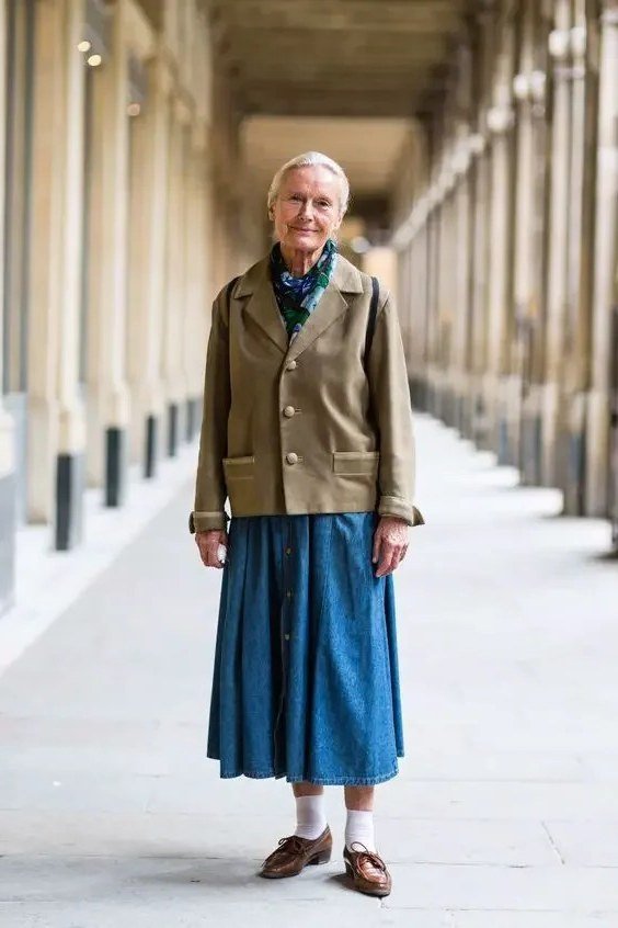 Fall city outfit for women over 50: olive jacket blue pleated midi skirt