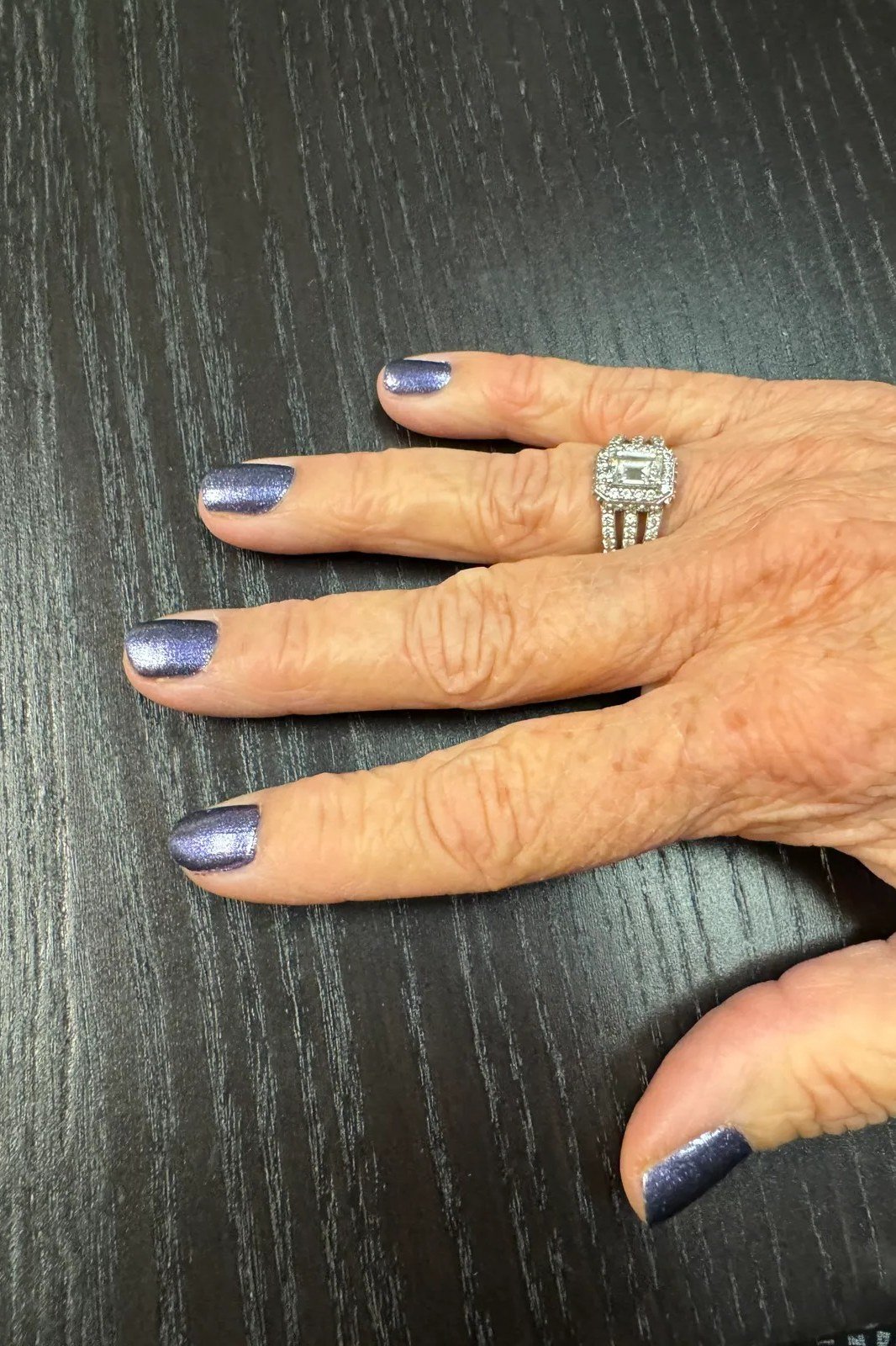 dusty blue on mature hand, dark wood
