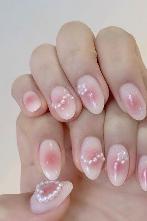 Pink blush nails with pearl ring nail art