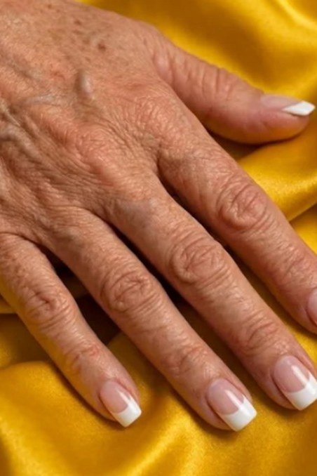 short squoval, white french, very mature hand on yellow satin , for women over 60