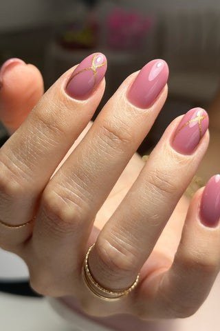 Mauve Almond Nails with Gold Band Accents, elegant mauve nail idea for women over 60