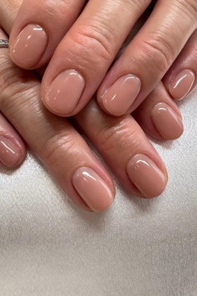 Glossy nude beige mature hands nails for women over 50