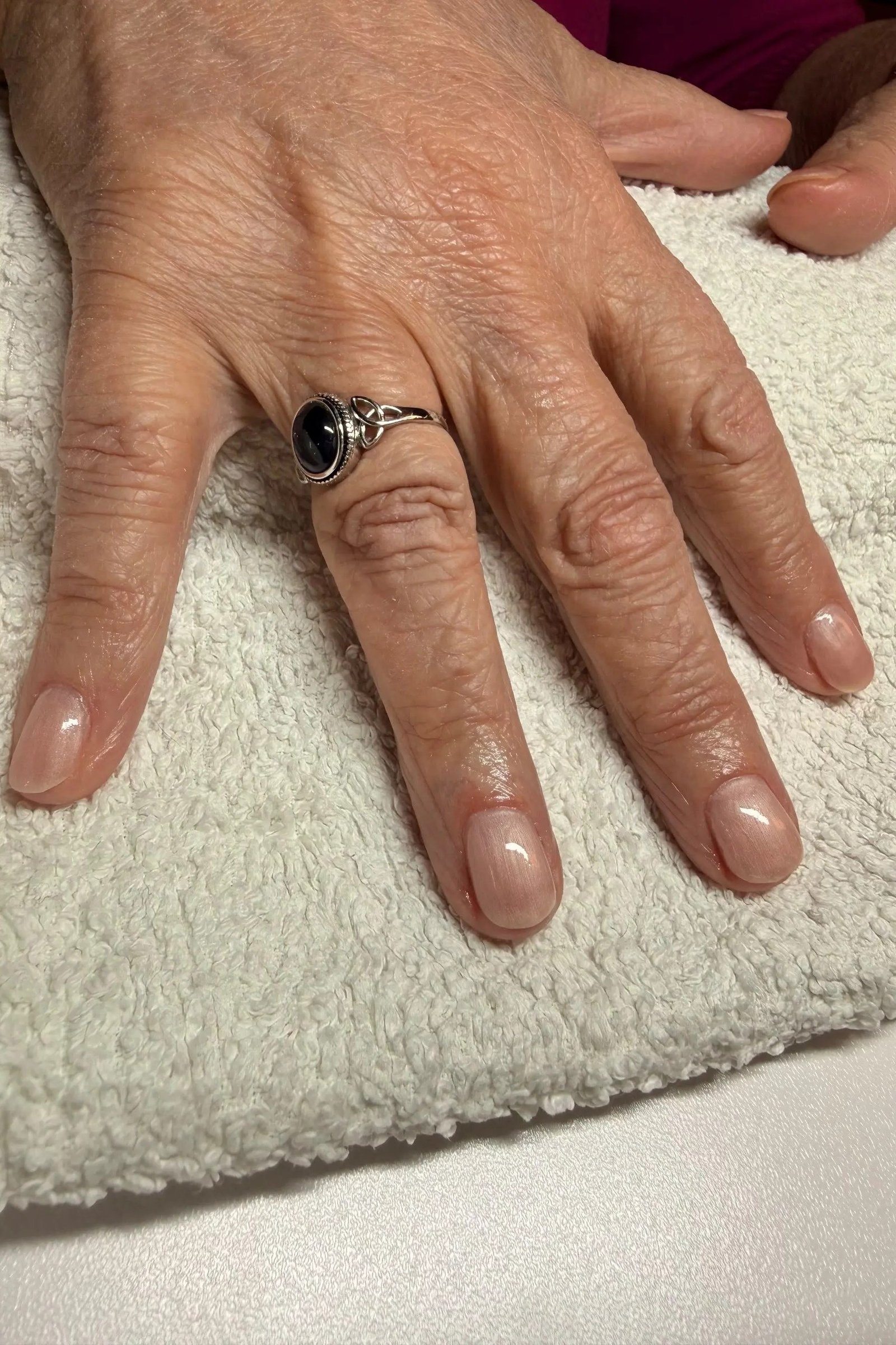 Sheer nude nails on elderly hands