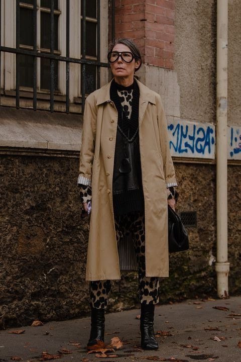 Fall city outfit for women over 50: camel trench black top leopard pants