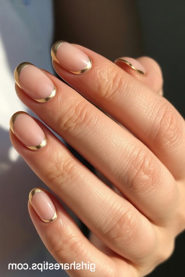 Nude Almond with Gold Outline Tips - short nude nail idea for women over 50