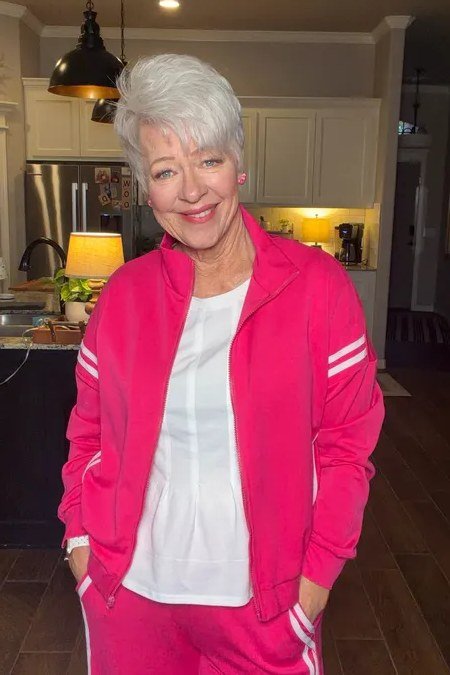 Woman over 50 wearing hot pink track jacket set, everyday casual outfit idea