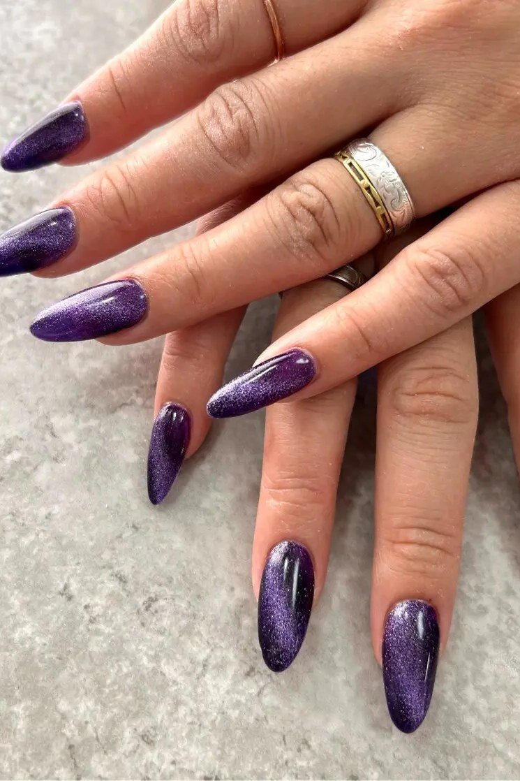Deep Purple Cat Eye Nails - Rich deep purple with sparkling magnetic shimmer covers these long almond nails.