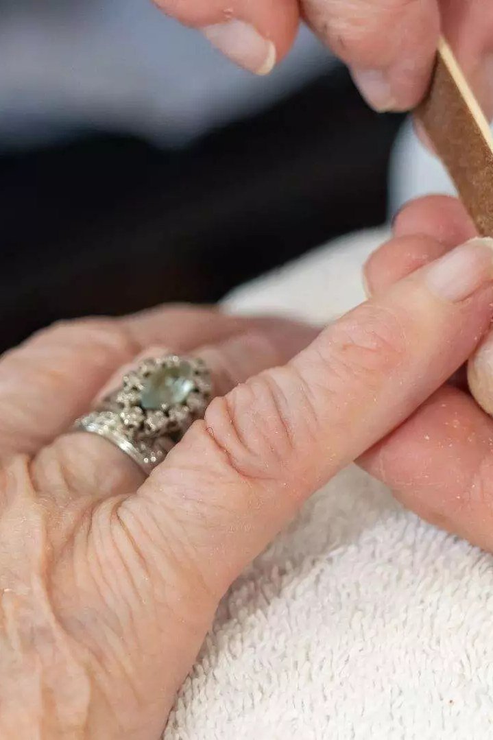 Smoothing a nail snag immediately on mature hands