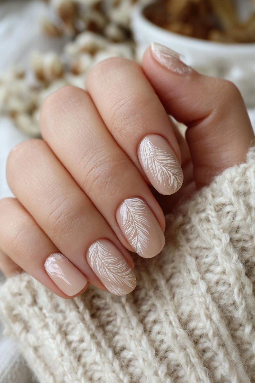 White leaf nail art on nude, sophisticated nail design for women over 50