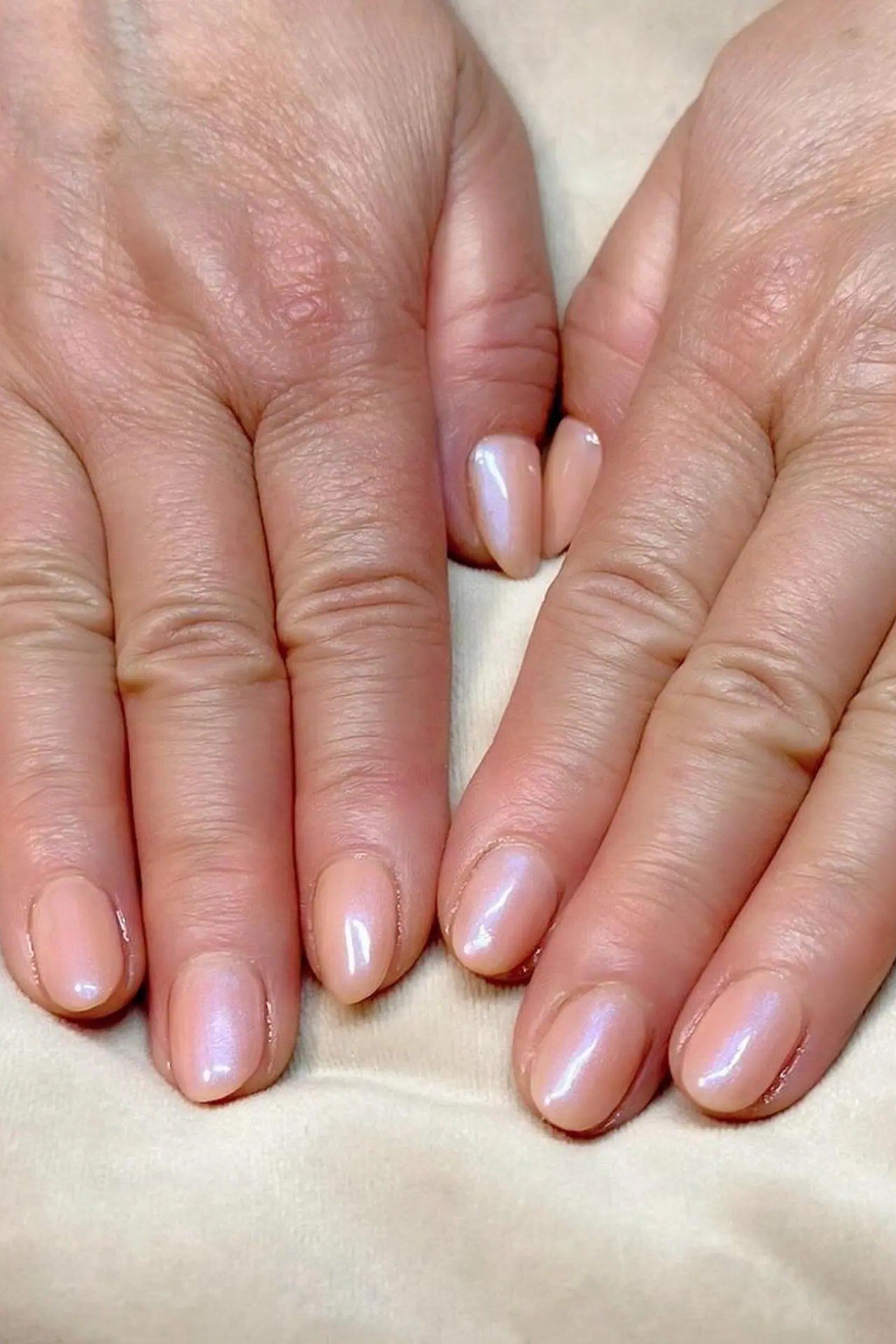 Pearly pink older hands nails for women over 50