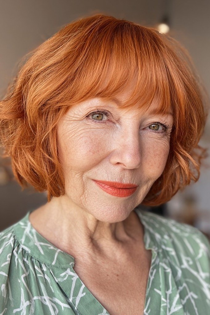 Copper curly lob with curly bangs, front view, older woman