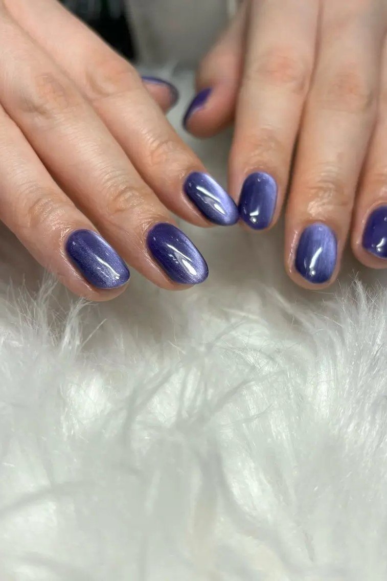 Indigo Cat Eye Nails - Rich indigo blue purple with soft magnetic shimmer covers these short, oval nails.