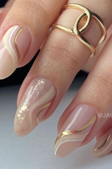 Nude almond gel nails with gold swirl lines