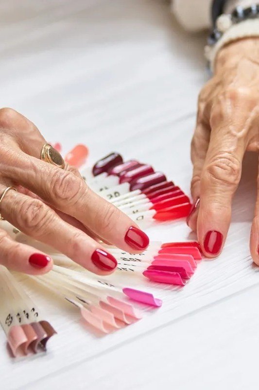 red nails with a polish palette for older women