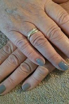 Dusty blue nail polish on older hands