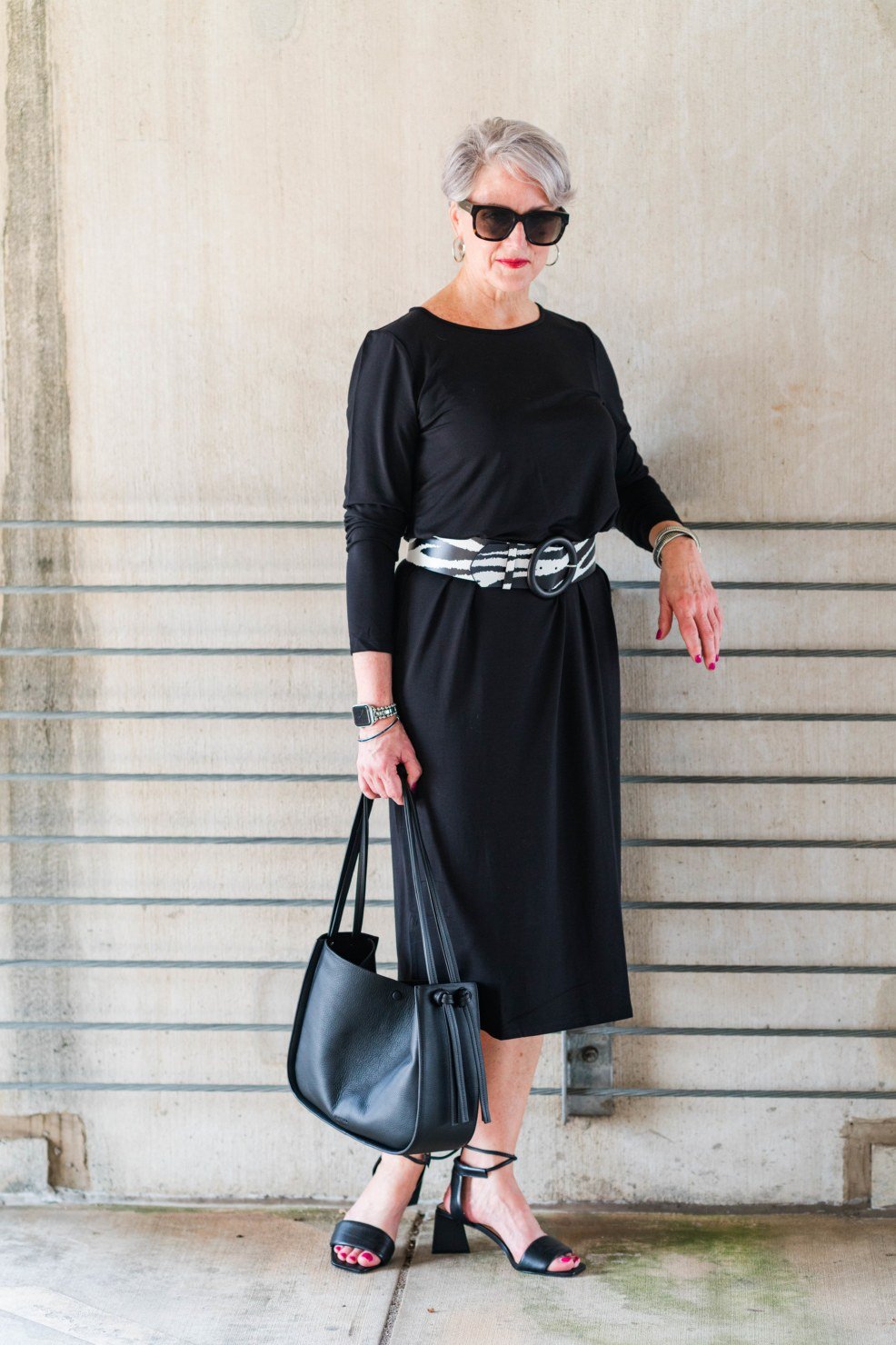 Black three-quarter-sleeve dress with silver belt for women over 50