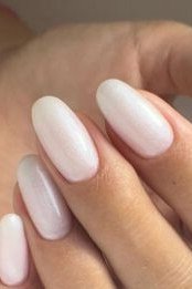 Collage of milky white nails shown from multiple angles