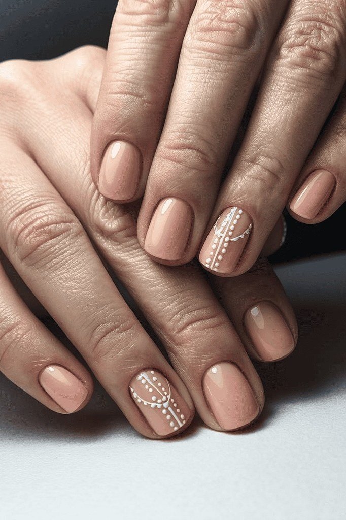 Warm Nude with Pearl Dot Art - short nude nail idea for women over 50