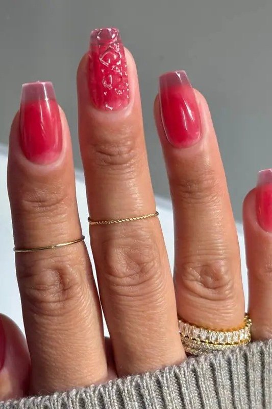 Squoval red jelly nails with glitter accents