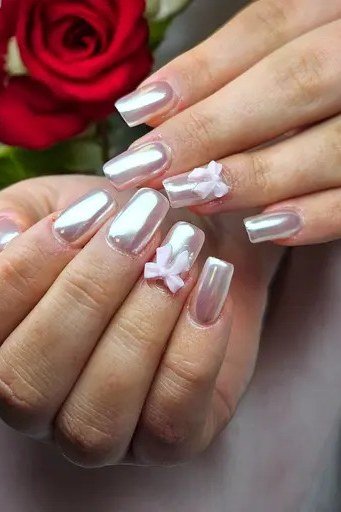 White Pearl Almond Nails with Pink Bows - pearl finish nail idea for women over 60