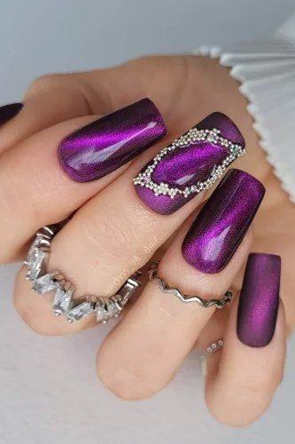 Magenta Cat Eye with Rhinestone Frame - Vivid magenta purple cat eye shimmer covers medium length squoval nails, with a rhinestone frame accent on one nail.