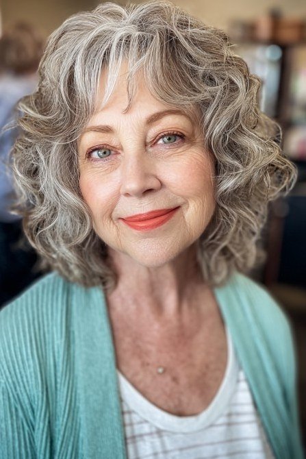 grey curly bob with soft bangs, front view hairstyle for women over 70