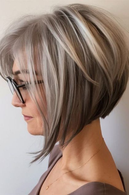 Silver french bob with grey streaks and glasses in side view