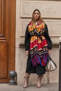 Black coat with bold colorful silk scarf and dark trousers, woman over 50