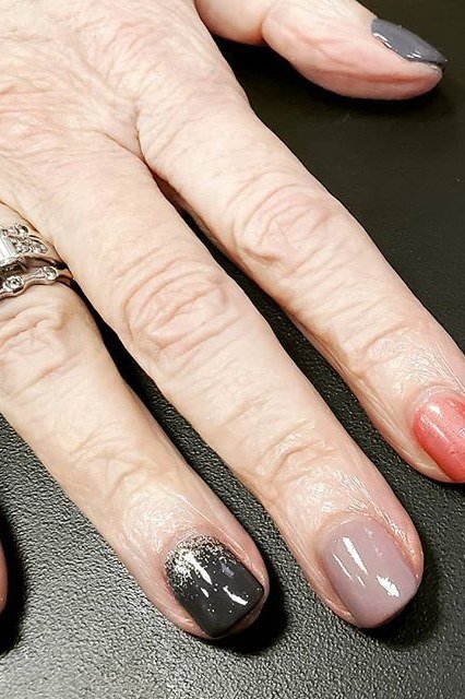 Nude gel nails with black glitter accent for mature hands