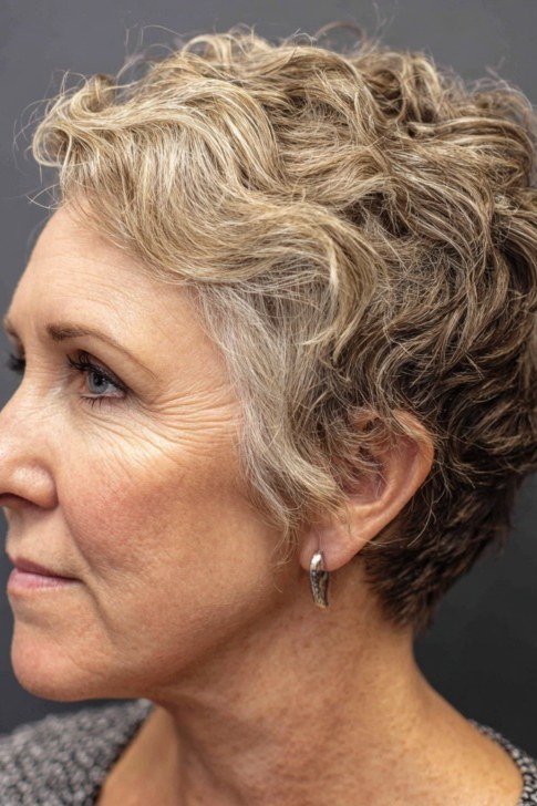 Blonde wavy bixie haircut side view for women over 60