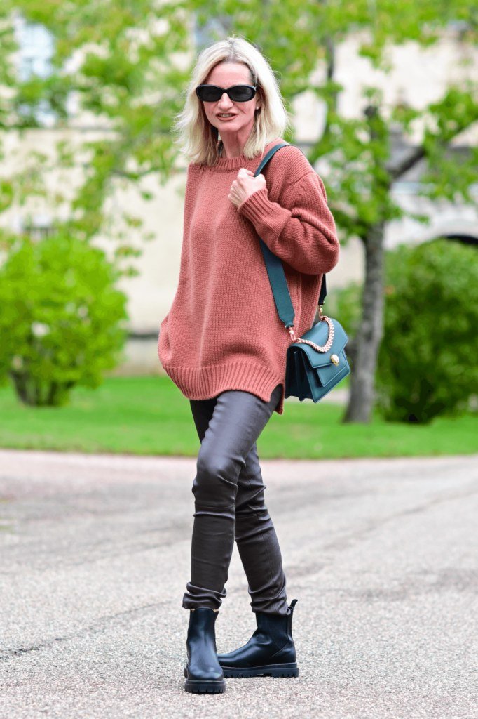 Rust oversized sweater leather leggings rust oversized sweater black leather pants black boots blonde - fall outfit idea for women over 40