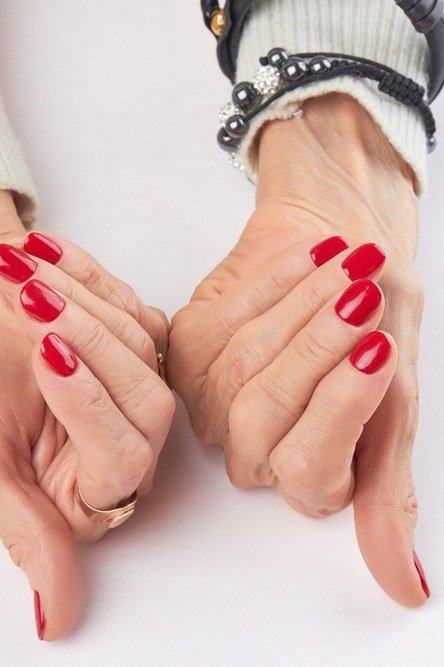 Red Nails with a Gold Bracelet gel nails for women over 60